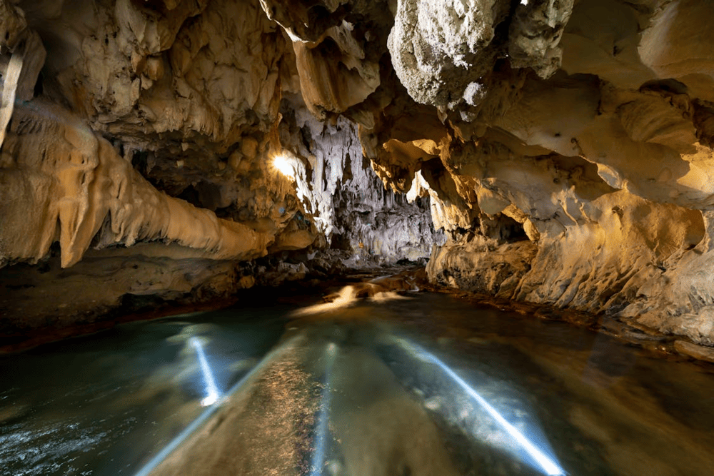 The underground river flows silently through the cave, adding to its mysterious allure (Source: Pexels)